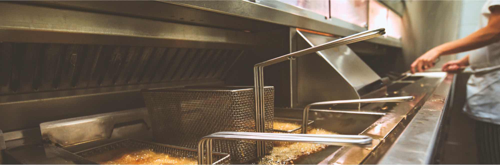 Chef is pictured frying chips in a deep fryer